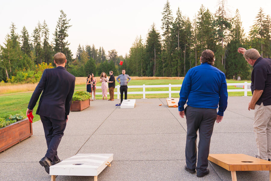 Guest playing cornhole on the patio