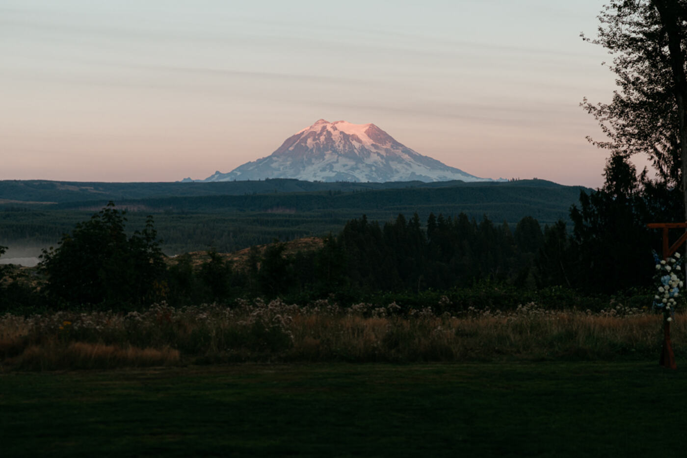Pink sunset over Mount Rainier with the ceremony arbor in view